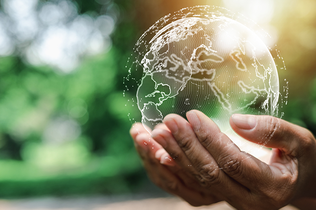 hands holding a bubble with a world map on it